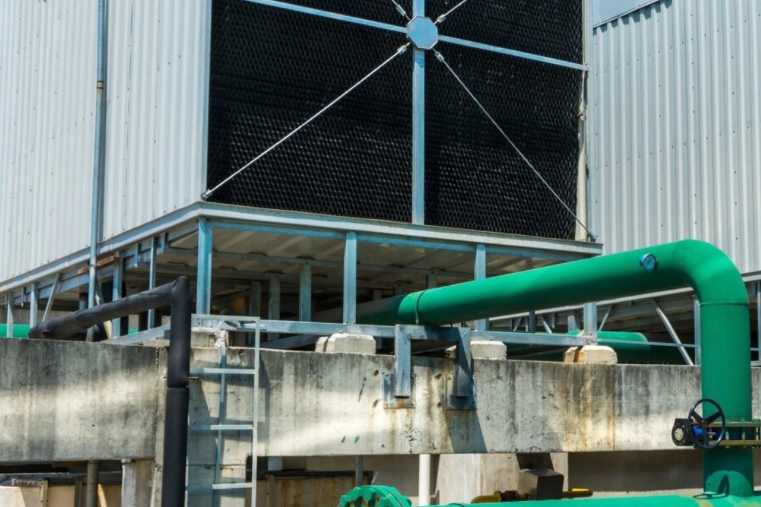 Outdoor cooling tower and green condenser piping for Newton Technology Group chiller monitoring