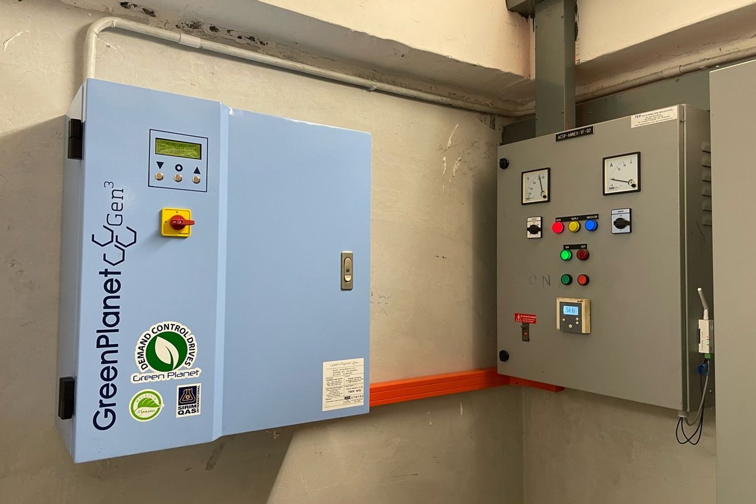 GreenPlanet Gen³ Demand Control Drives panel installed beside a grey control cabinet in a plant room
