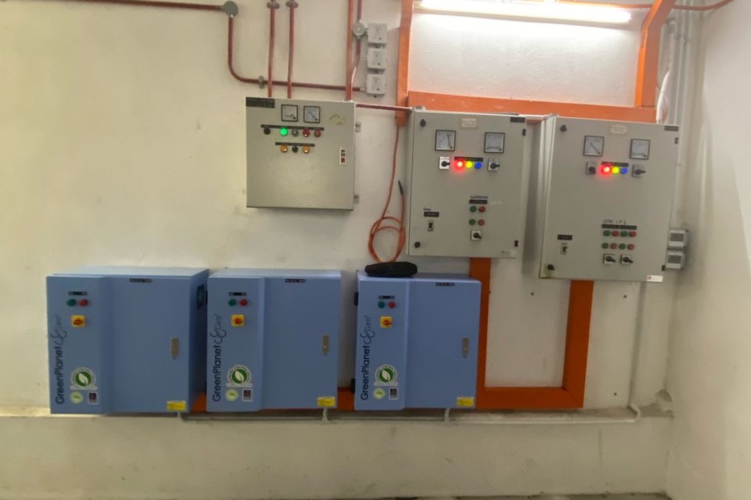 Three GreenPlanet Gen³ Demand Control Drives cabinets mounted under grey control panels in a plant room